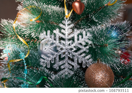 Christmas crystal snowflake on Christmas tree with blue Ribbon Christmas crystal snowflake on Christmas tree with blue Ribbon 108793511