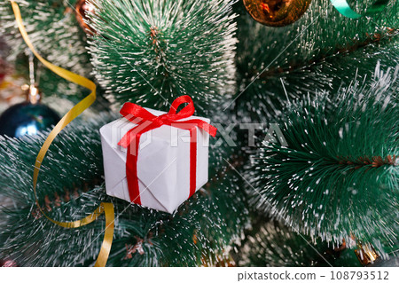 New Year white Gift Box or Christmas tree with gold Ribbon New Year white Gift Box or Christmas tree with gold Ribbon 108793512