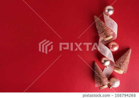 Pink Christmas trees and baubles decoration on red background with copy space. New Year greeting card. Flat lay 108794268