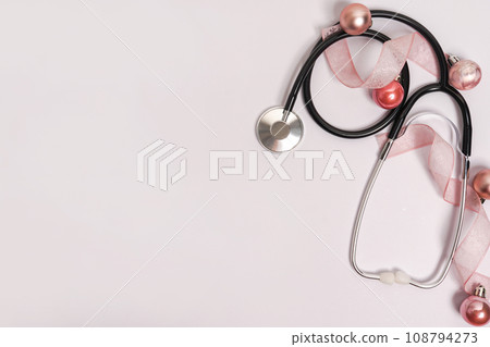 Christmas medicine white background with stethoscope and new year pink decor, concept of medical winter holiday Christmas medicine white background with stethoscope and new year pink decor, concept of medical winter holiday 108794273