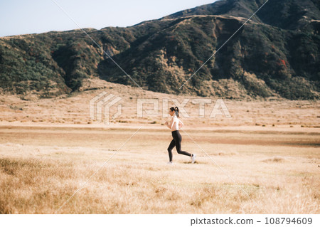 A woman jogging in nature A woman jogging in nature 108794609