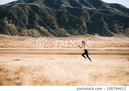 A woman jogging in nature 108794612