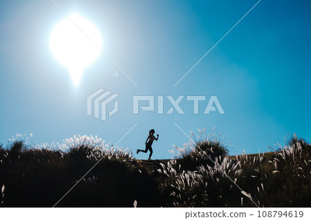 A woman jogging in nature 108794619