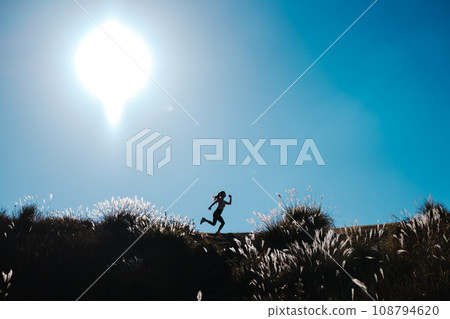 A woman jogging in nature 108794620