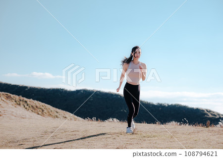 A woman jogging in nature 108794621