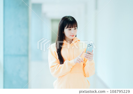 A female university student operates a smartphone. Photography cooperation: Ariake College of Education and Arts A female university student operates a smartphone. Photography cooperation: Ariake College of Education and Arts 108795229