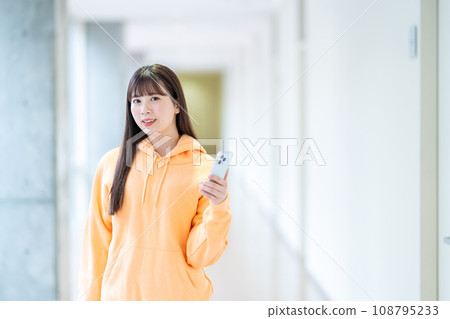 A female university student operates a smartphone. Photography cooperation: Ariake College of Education and Arts A female university student operates a smartphone. Photography cooperation: Ariake College of Education and Arts 108795233