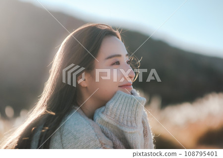 A woman camping solo in nature 108795401