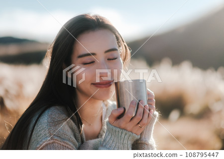 A woman camping solo in nature 108795447