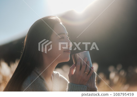 A woman camping solo in nature 108795459