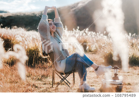 A woman camping solo in nature 108795489