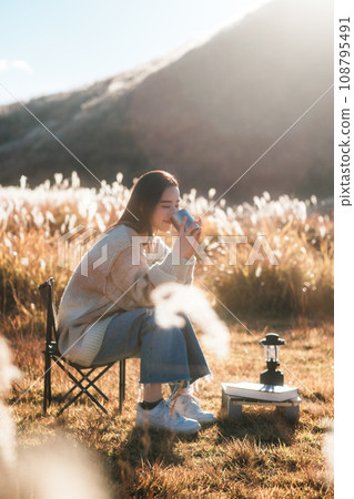 A woman camping solo in nature 108795491