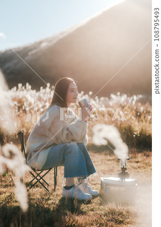 A woman camping solo in nature A woman camping solo in nature 108795493