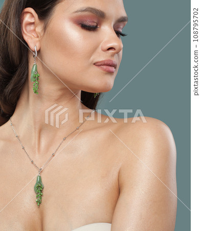 Attractive glamorous woman with natural shiny clean skin wearing jewelry golden necklace 108795702