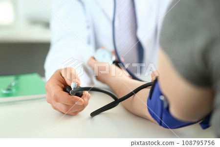 Doctor checking blood pressure 108795756