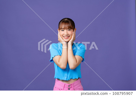 Beautiful young woman waiting for something, holding hands on her face, smiling and looking at camera with happy, Beautiful young woman waiting for something, holding hands on her face, smiling and looking at camera with happy, 108795907
