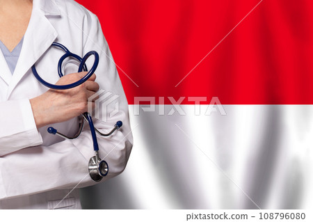 Indonesian medicine and healthcare concept. Doctor close up against flag of Indonesia background Indonesian medicine and healthcare concept. Doctor close up against flag of Indonesia background 108796080