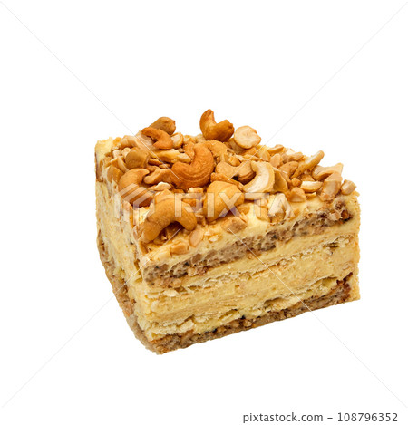 A piece of Cashew cake based on protein layers with cashews, custard and chocolate isolated on white A piece of Cashew cake based on protein layers with cashews, custard and chocolate isolated on white 108796352