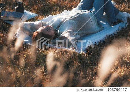 Female solo camp lying down relaxing 108796437