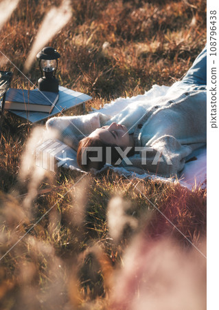 Female solo camp lying down relaxing 108796438