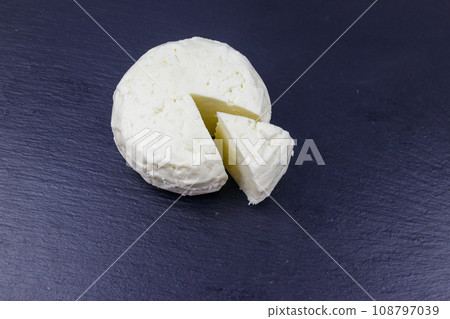 Soft Adyghe cheese on black slate background 108797039