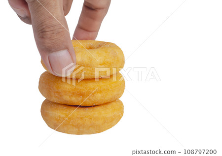 Hand with Donuts cake bakery sprinkled with sugar on white 108797200