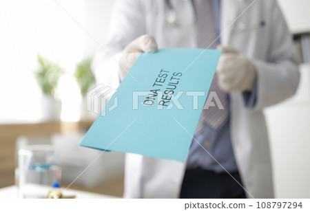 Male doctor hand holds out an envelope Male doctor hand holds out an envelope 108797294