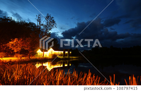 Rustic brick house with light against Rustic brick house with light against 108797415