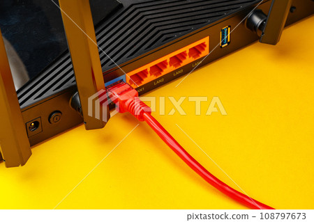 Colored network cable patch-cord on yellow background 108797673