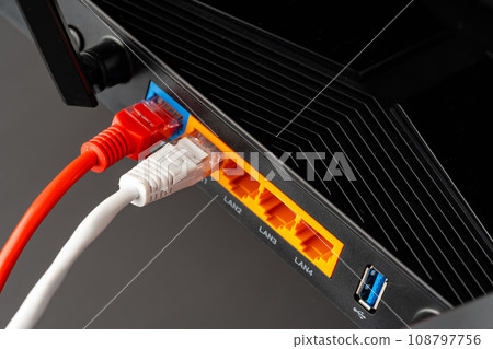 Modern router with cables plugged in close up Modern router with cables plugged in close up 108797756