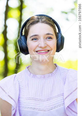 Music Bliss: Woman with Headphones in Nature 108797866