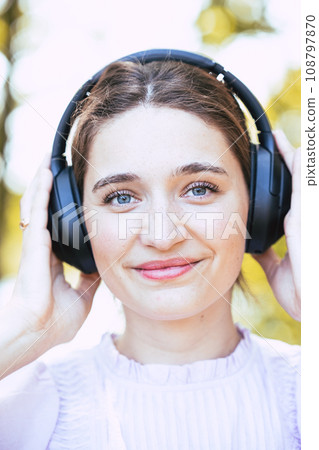 Music Bliss: Woman with Headphones in Nature 108797870