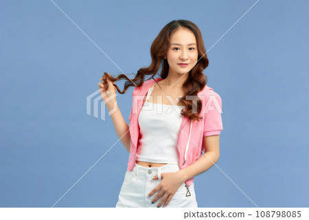 Attractive young woman in a pink hoodie Attractive young woman in a pink hoodie 108798085