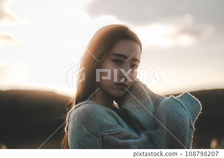 A woman with a sad expression in nature 108798207