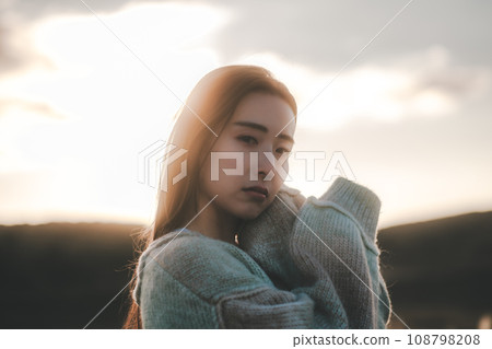 A woman with a sad expression in nature A woman with a sad expression in nature 108798208