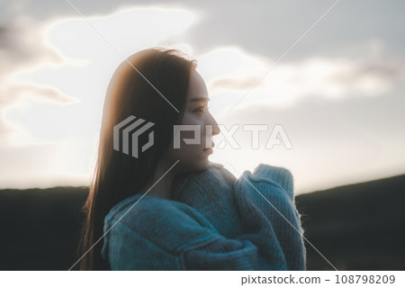 A woman with a sad expression in nature 108798209