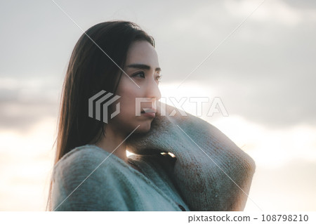 A woman with a sad expression in nature 108798210