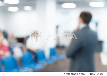 Male speaker at a conference, seminar, lecture. Personal growth training or business training. People's faces are not visible in the photo. Blurred. High quality photo 108798385