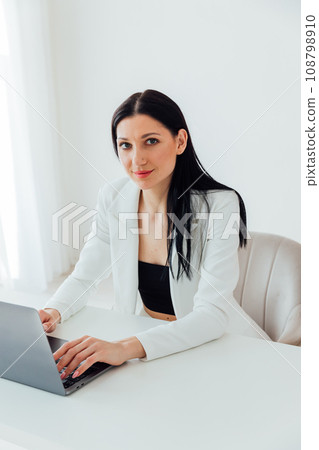 Businesswoman with hand on chin using smart phone at coffee shop Businesswoman with hand on chin using smart phone at coffee shop 108798910