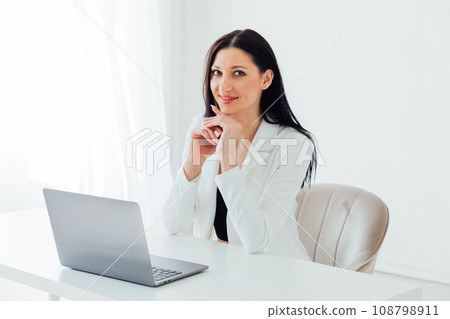 Businesswoman with hand on chin using smart phone at coffee shop Businesswoman with hand on chin using smart phone at coffee shop 108798911