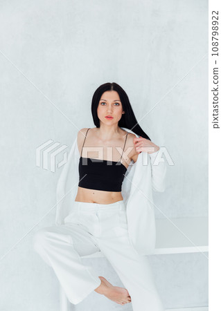 Beautiful fashionable brunette woman in white business suit 108798922