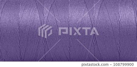 Texture of threads in a spool of purple color on a white background Texture of threads in a spool of purple color on a white background 108799900