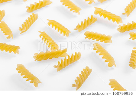 Pasta products in the form of a spiral, texture, on a white background 108799936