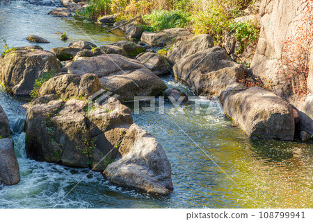 flow of water and spray from a stone 108799941