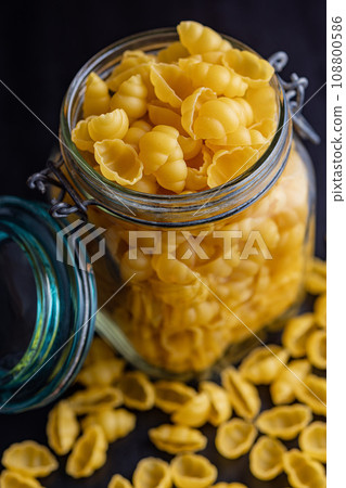 Uncooked gnocchi pasta. Raw italian pasta in jar. Uncooked gnocchi pasta. Raw italian pasta in jar. 108800586