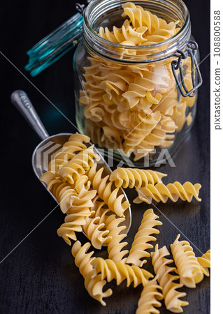 Uncooked fusilli pasta. Uncooked italian pasta in scoop. Uncooked fusilli pasta. Uncooked italian pasta in scoop. 108800588