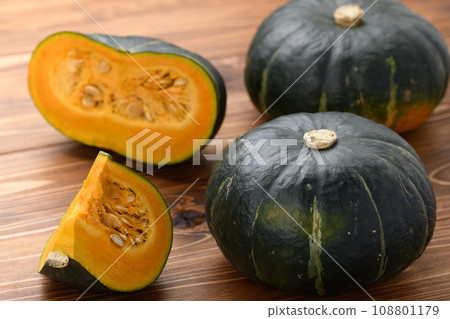 Pumpkin and cut pumpkin wood grain background Pumpkin and cut pumpkin wood grain background 108801179