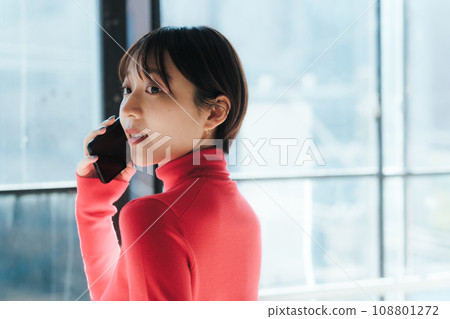 Smartphone: A woman using a mobile phone 108801272