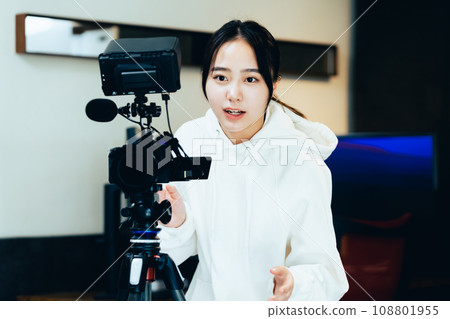 young woman filming a video 108801955
