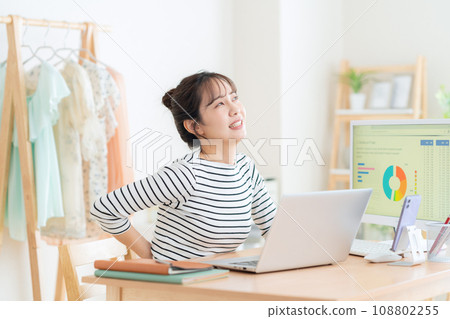 A young woman working from the living room during telework 108802255